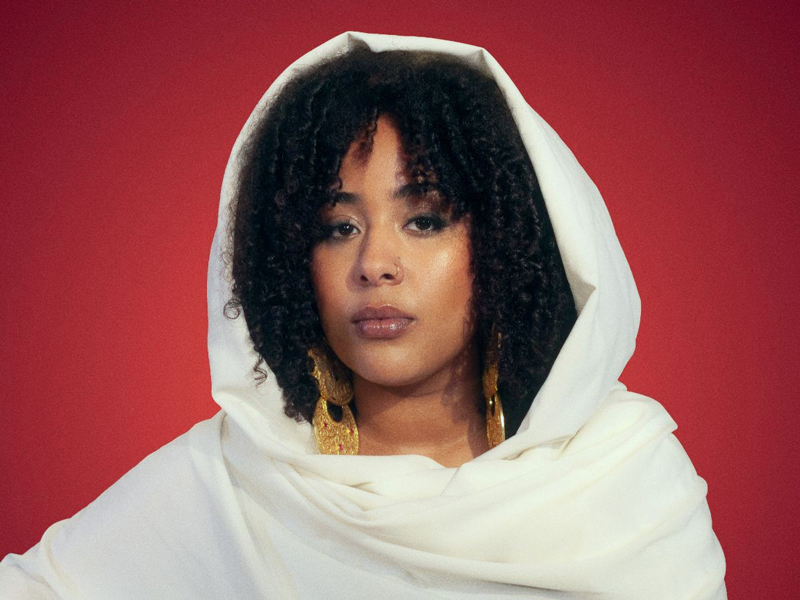 A headshot of Sulaf wearing a traditional white outfit.