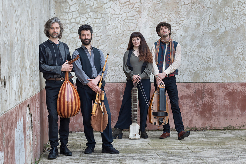Toasaves - Photo by Laura Soriano. Band photo. The musicians leaning againist a wall holding their musical instruments.