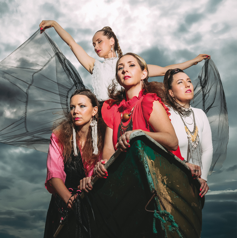 Tuuletar - Maammo cover artwork. A photo of the four female singers in a small boat.
