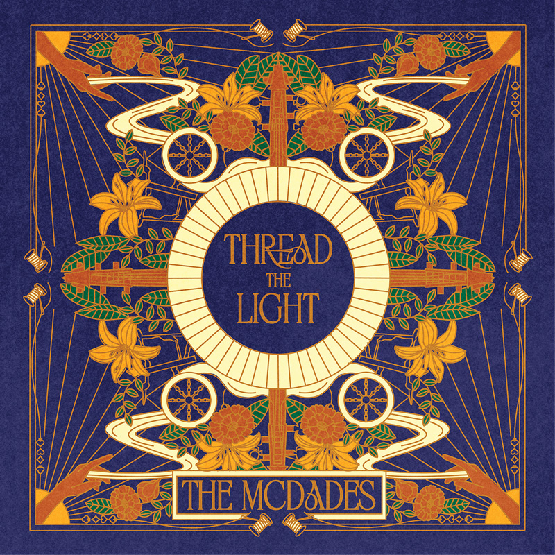 The McDades - Thread The Light cover artwork. An ornate, symmetrical Art Deco-style cover in indigo, gold, cream, and green. Floral motifs, geometric lines, circular emblems, and mirrored architectural forms radiate around a central sunburst medallion containing the title Thread The Light.