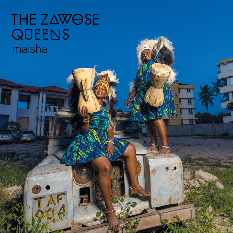 The Zawose Queens - Maisha cover artwork. The photo shows the two sisters holding drms, standing on top of a Land Rover.