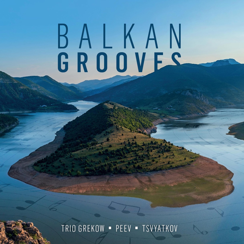 Trio Grekow / Peev / Tsvyatkov - Balkan Grooves cover artwork. A photo of a scenic landscape with a peninsula in the middle surrounded by a meandering river or lake.