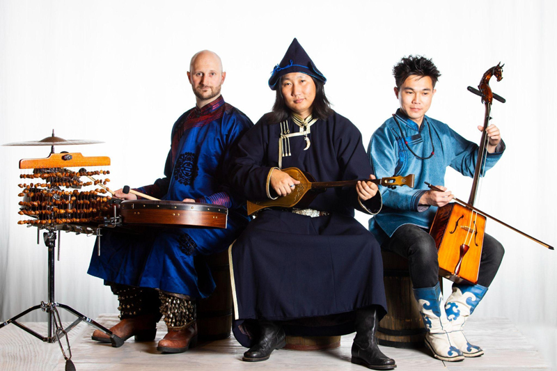 Tuvergen Band - Photo by Susie Inverso. The three members of the band wearing traditional clothes, playing traditional instruments.