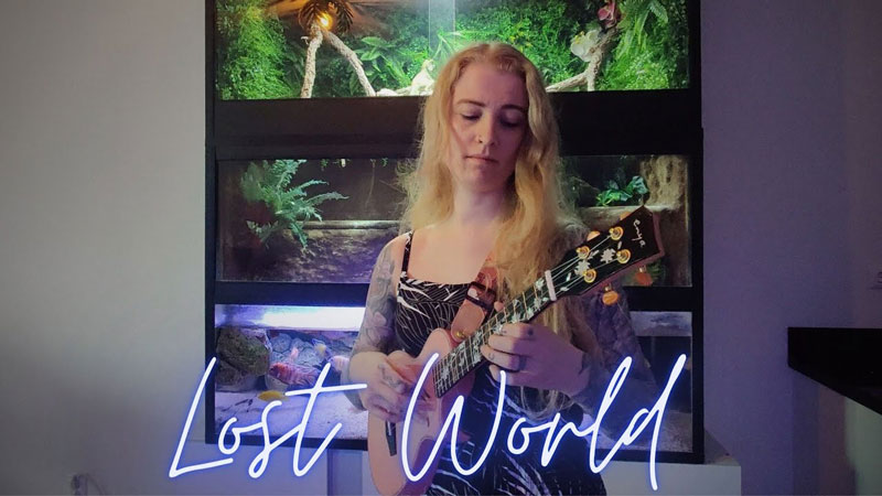Ukulele MJ - Lost World screen shot from the video. The artist playing ukulele in front of an aquarium.