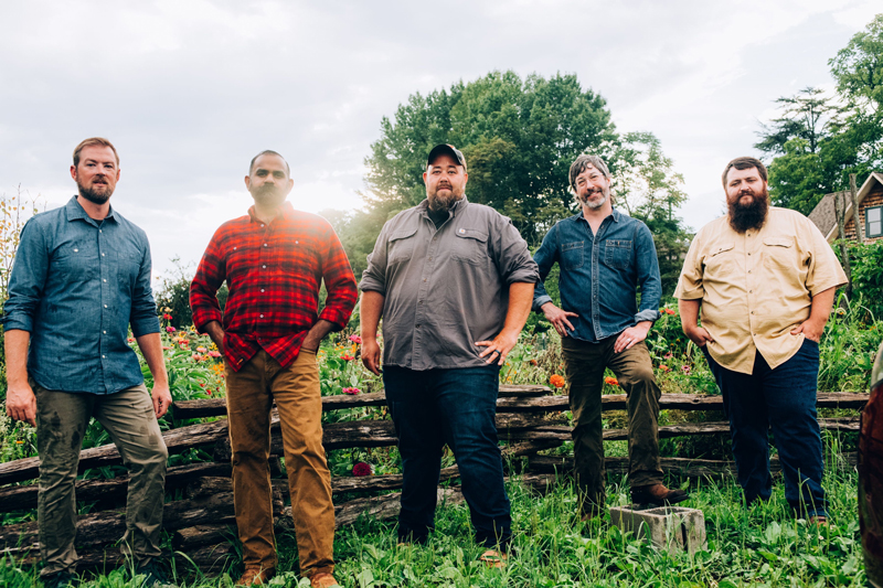 Unspoken Tradition band photo. The musicians standing outdoors.