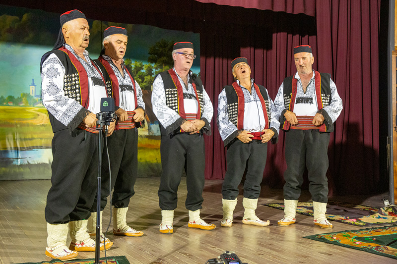 Made in Vojka: Serbian Songs. A group of male singers in traditional clothing on stage.
