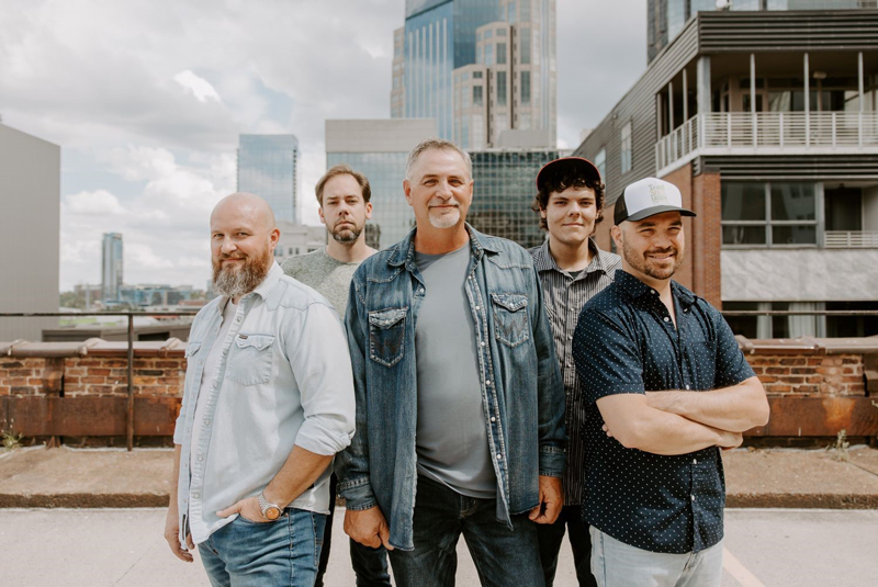 Volume Five band photo, posing in a downtown high rise area.