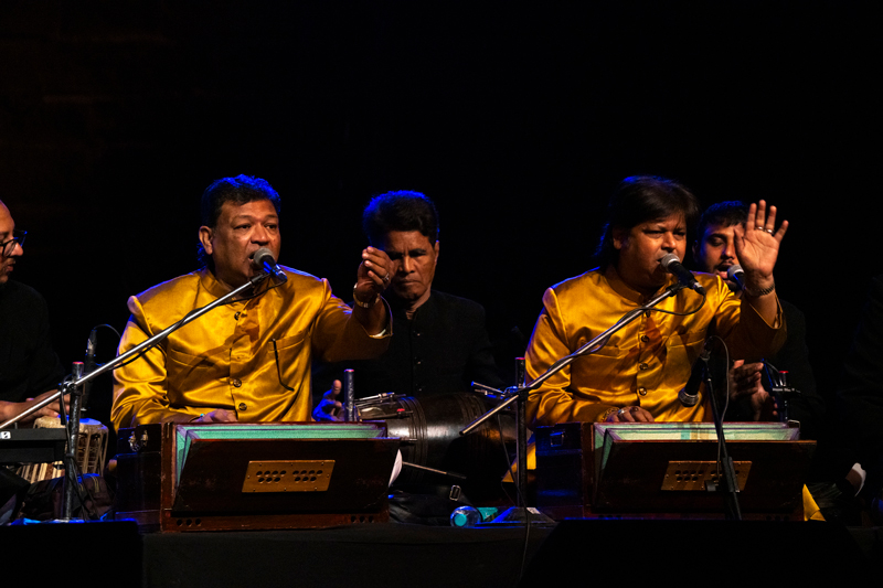 The Warsi Brothers performing on stage.