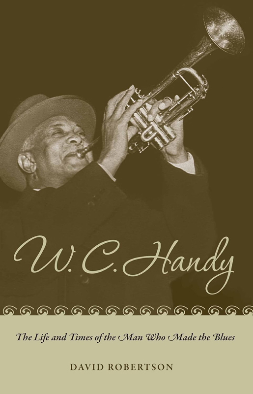 Cover of the book W. C. Handy: The Life and Times of the Man Who Made the Blues by David Robertson. An image of Handy playing trumpet.