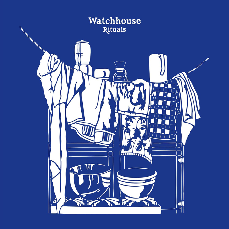 The album cover for Rituals by Watchhouse features a two-tone illustration in white against a deep blue background. It depicts a domestic scene: a dish rack or shelf lined with bowls and kitchenware, draped with various cloths and towels.