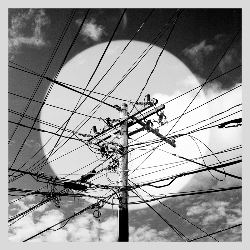 Yann Falquet - Les Secrets Du Ciel cover artwork. A photo of power lines.