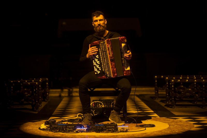 Yegor Zabelov - photo by Ana Maria Dinis. Zabelov on stage with his accordion and effect pedals.
