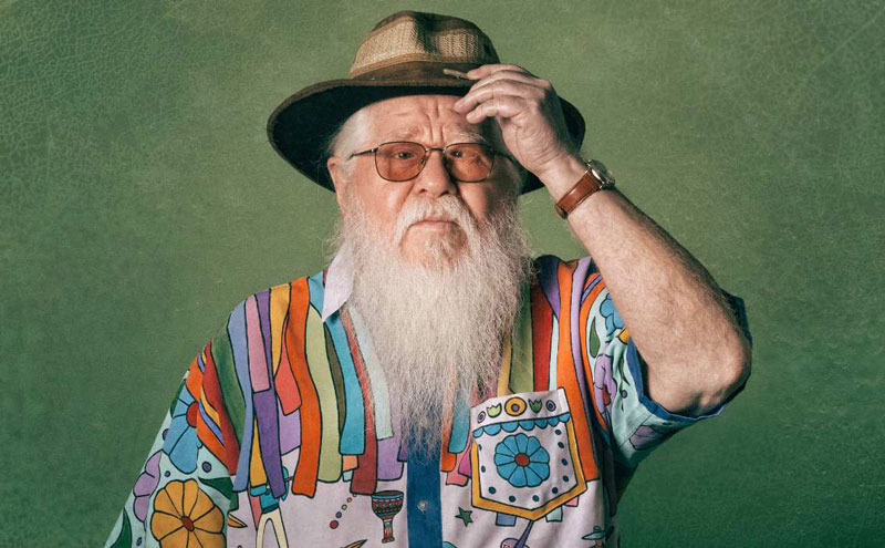 Hermeto Pascoal - Photo by Gabriel Quintao. the artist wearing a colorful shirt and hat.