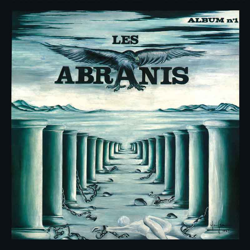 The cover of Album n°1 by Les Abranis features a monochromatic landscape framed by two rows of stone columns stretching into the distance. Broken chains lie scattered across the ground, with a human figure collapsed in the foreground. Above, a large black eagle spreads its wings over the band’s name.