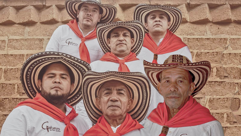 Los Gaiteros De San Jacinto band photo wearing tradiitonal white clothes and red scarves