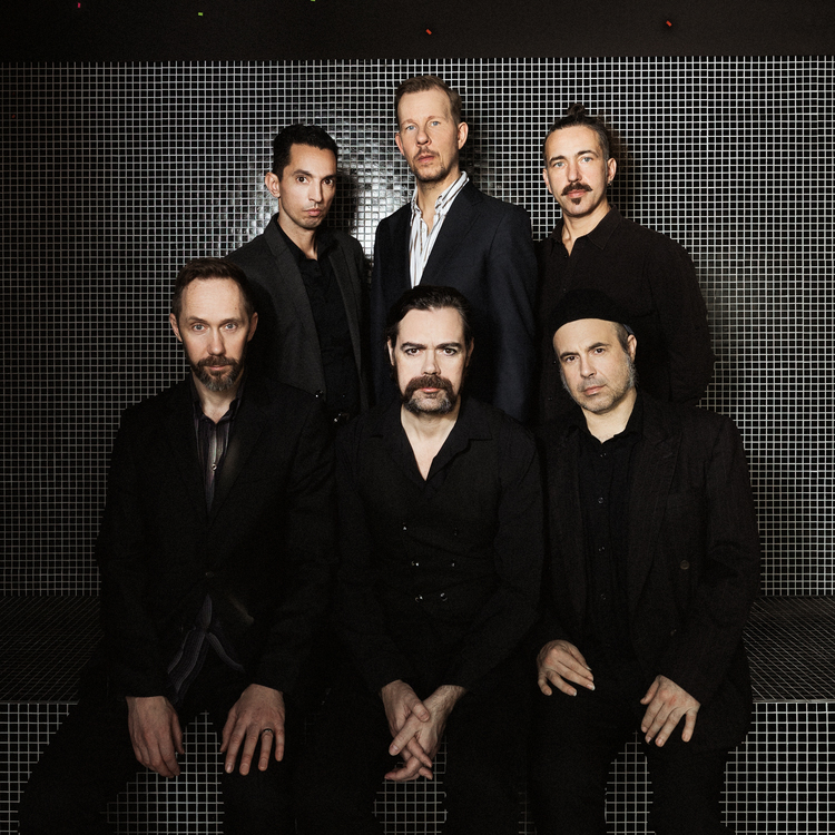 Lusitanian Ghosts band photo. Six members dressed in black.