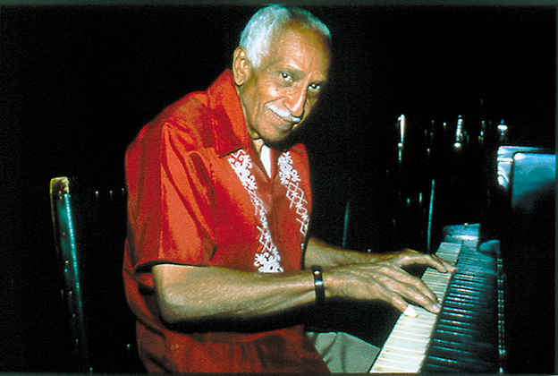 Rubén González playing piano.